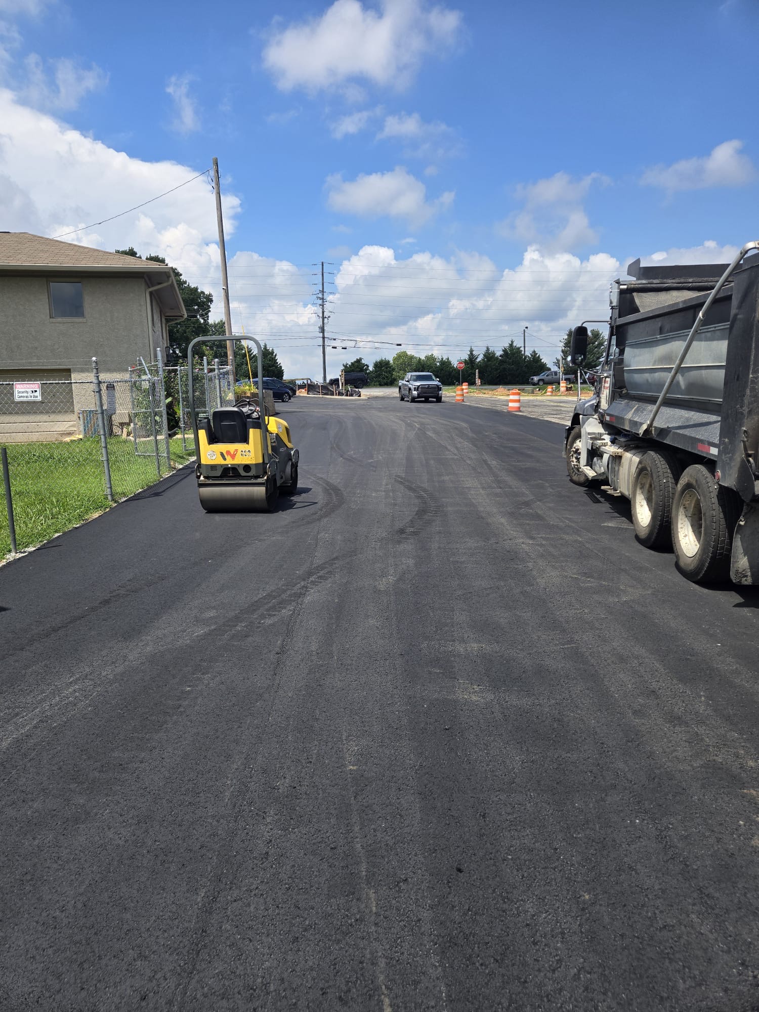 Roller compacting a newly overlaid residential street
